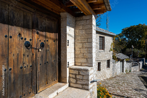 Wooden door of an old stone house in the traditional village of Vitsa in Zagori, Greece photo