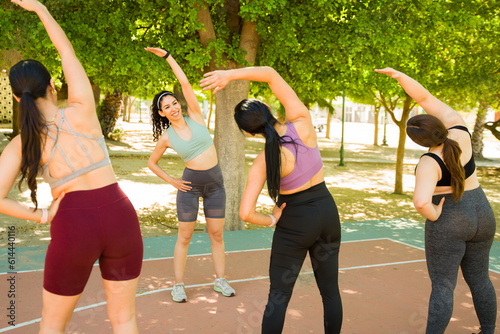 Group fitness class exercising in the park