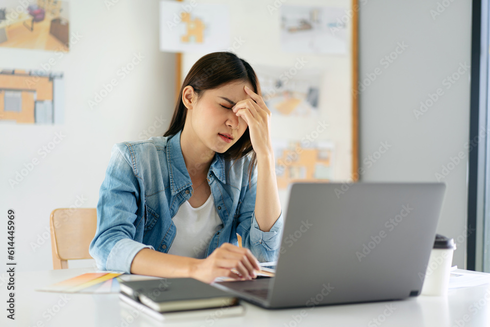 Woman architect stressful and suffering headache with sketching Woman architect stressful and suffering headache with sketching