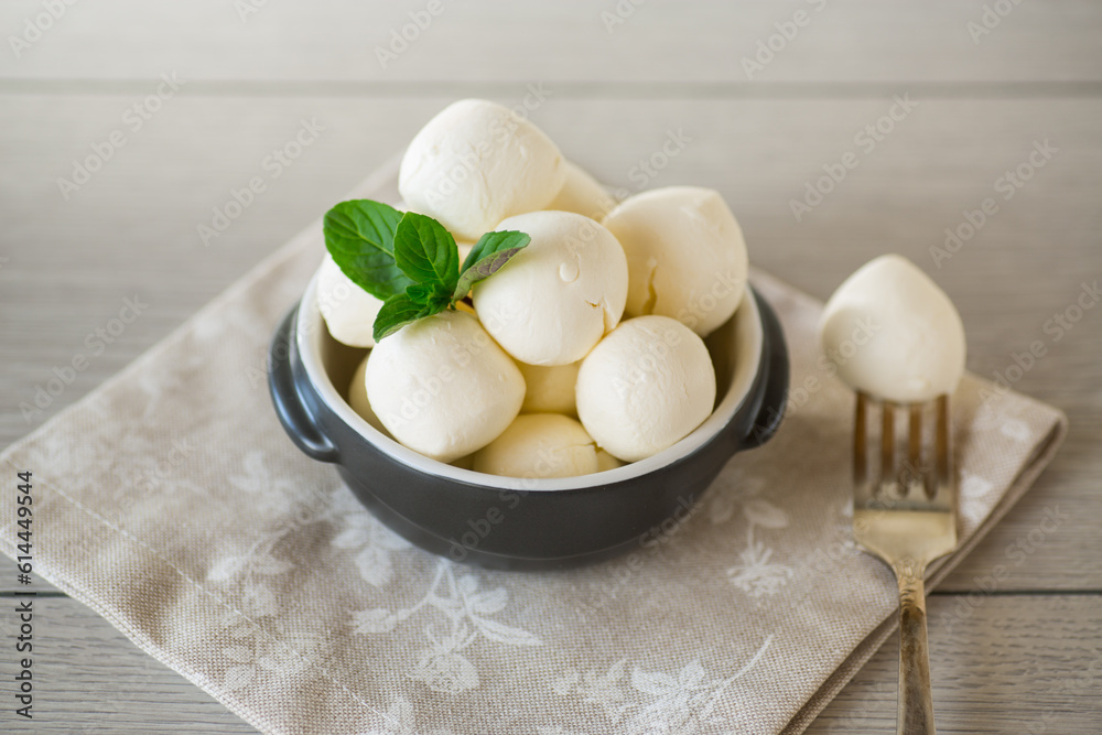 Small balls of traditional mozzarella in a ceramic bowl Small balls of traditional mozzarella in a ceramic bowl