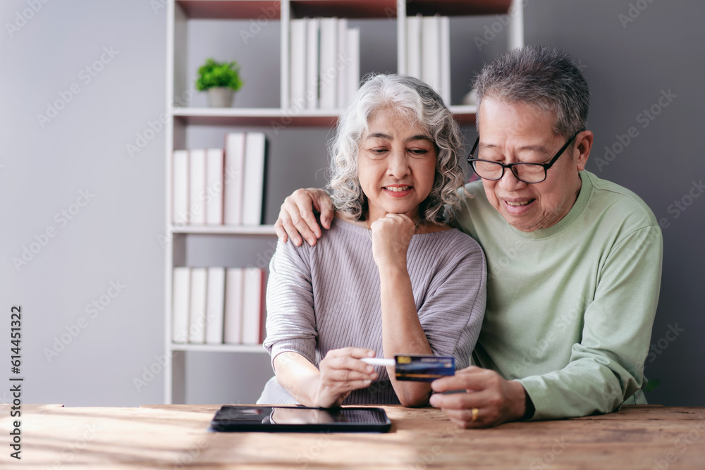Senior couple using digital tablet and credit card to buying lif Senior couple using digital tablet and credit card to buying lif
