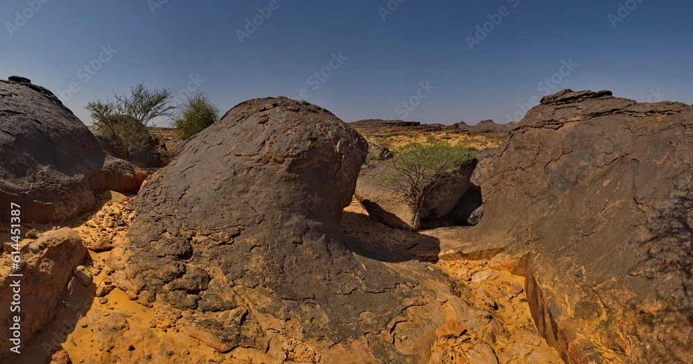 West Africa. Mauritania. Panorama of lava formations of ancient volcanoes on top of a destroyed plateau in the Agro Nature Park near the town of Shingetti. West Africa. Mauritania. Panorama of lava formations of ancient volcanoes on top of a destroyed plateau in the Agro Nature Park near the town of Shingetti.
