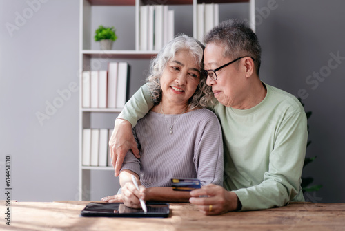 Senior couple using digital tablet and credit card to buying lif