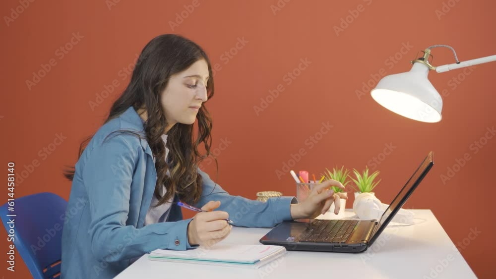 Young woman looking at laptop is unmotivated and bored. Young woman looking at laptop is unmotivated and bored.