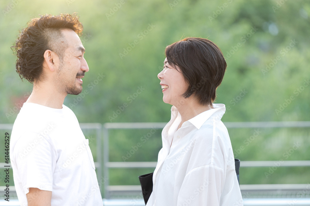 Middle-aged Asian (Japanese) couple smiling and looking at each other Close-up of upper body Middle-aged Asian (Japanese) couple smiling and looking at each other Close-up of upper body