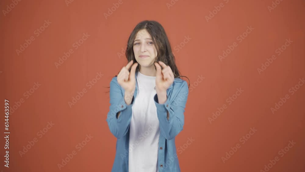 The young woman making the small sign with her hand. The young woman making the small sign with her hand.