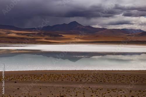 Temporale su montagne e riflesso su Laguna altopiano andino Atacama photo