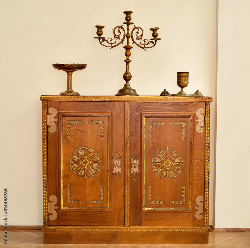 Rustic wooden dresser with antique brass candlestick and two dishes in ...