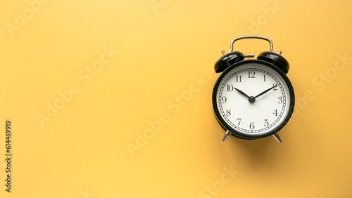 Concept of time, reminder, countdown, alert, deadline. Alarm clock isolated on yellow background.Copy space.