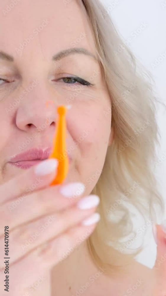 woman demonstrates new orange toothbrush She removes cap of special device for cleaning teeth and shows how to brush teeth properly clean food after woman demonstrates new orange toothbrush She removes cap of special device for cleaning teeth and shows how to brush teeth properly clean food after