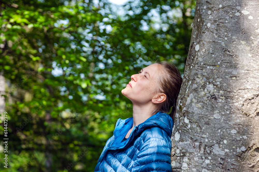 Person Leisurely Gazes up at Tree Amidst Spring Foliage Person Leisurely Gazes up at Tree Amidst Spring Foliage