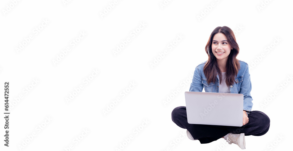 Young woman sitting on floor legs crossed using laptop computer on white background Smiling student teenager girl working on laptop computer Full body young girl work on netbook looking to empty space Young woman sitting on floor legs crossed using laptop computer on white background Smiling student teenager girl working on laptop computer Full body young girl work on netbook looking to empty space