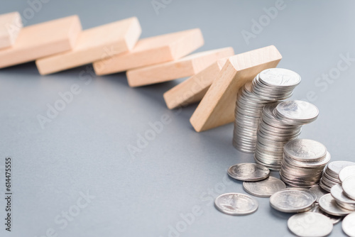 Canvastavla Domino effect impacts some of the heap of coins falling down, finance status, in