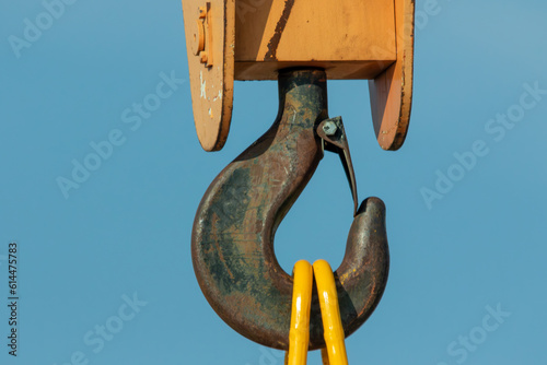 close up of gantry crane with hook against blue sky  photo