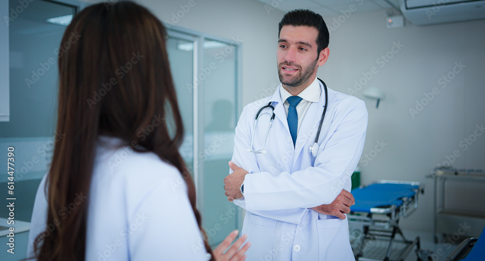 Two professional medical, Male doctor and asian female doctor colleague at work standing talk discuss about medical and patient in ward at hospital. Two professional medical, Male doctor and asian female doctor colleague at work standing talk discuss about medical and patient in ward at hospital.