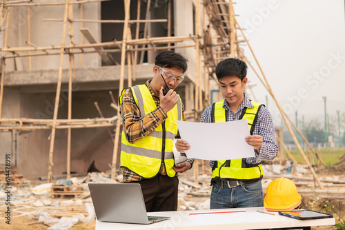 Civil engineers inspect work with walkie-talkies for communicating with the management team. Engineer recommends house construction to supervisor at construction site home building ideas