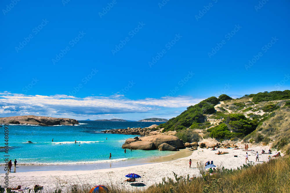 The idyllic Twilight Beach near Esperance, Western Australia, with holiday makers swimming in the sea and sunbathers relaxing on the beach
