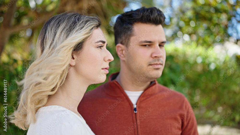 Man and woman couple standing together with relaxed expression at park Man and woman couple standing together with relaxed expression at park