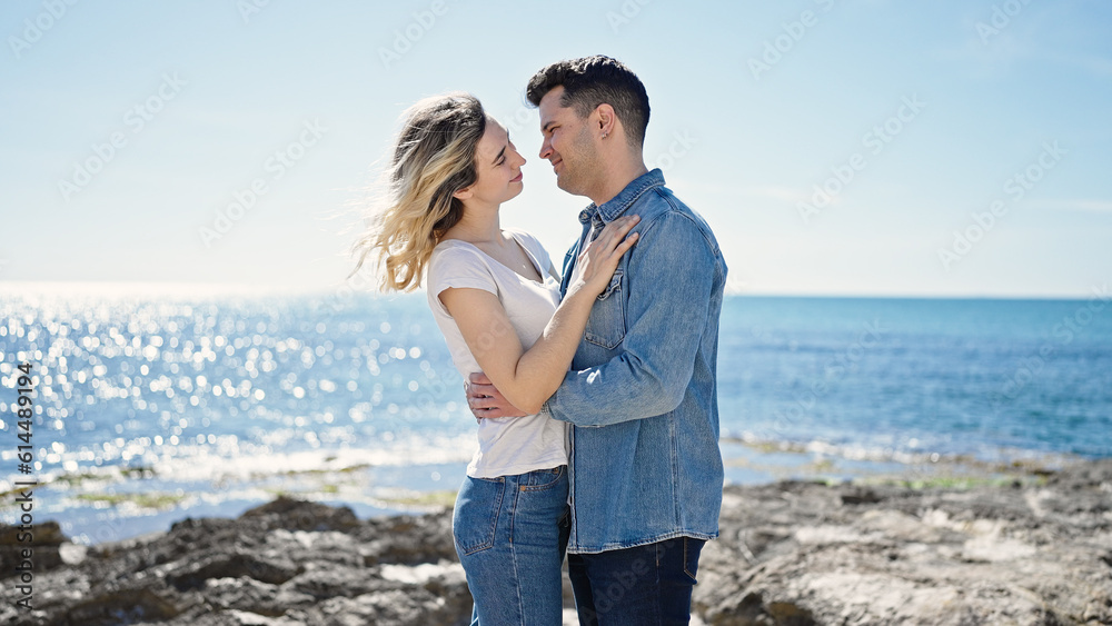 Man and woman couple smiling confident dancing at seaside