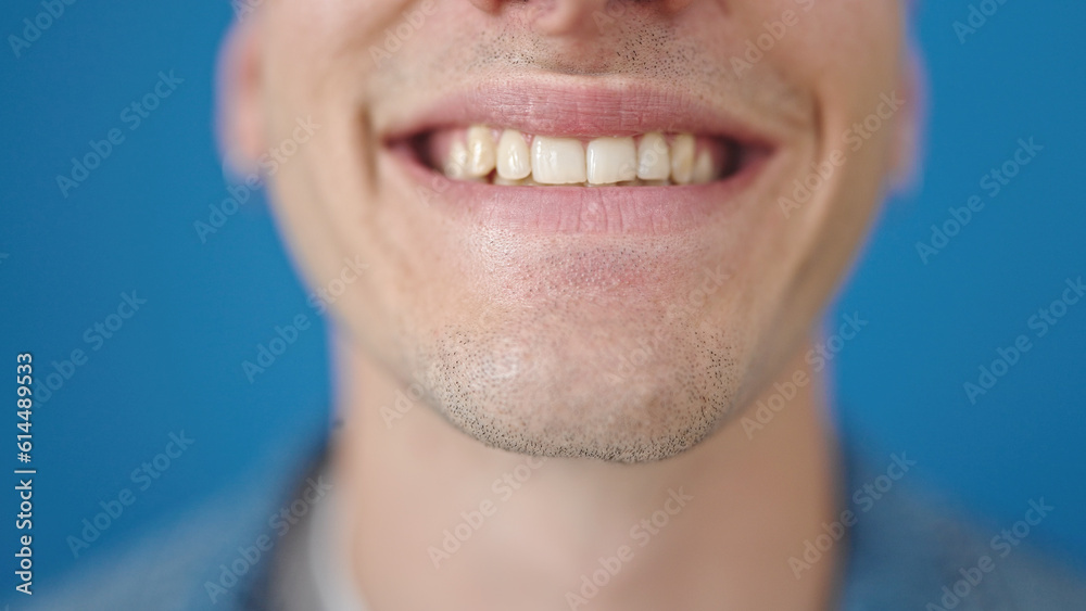 Young hispanic man smiling confident over isolated blue background Young hispanic man smiling confident over isolated blue background