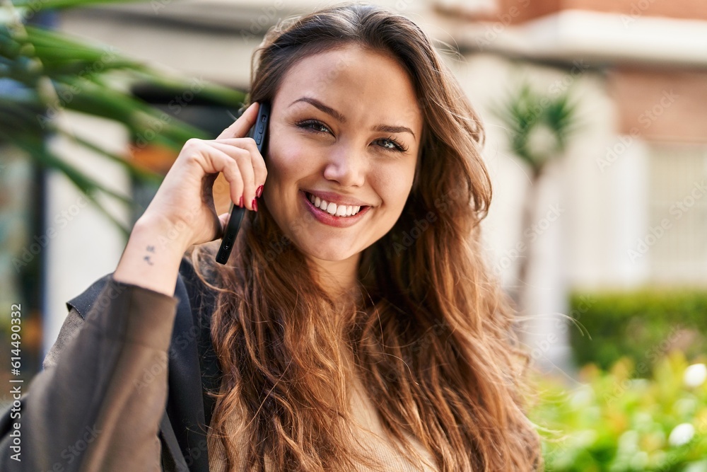 Young beautiful hispanic woman smiling confident talking on the smartphone at street Young beautiful hispanic woman smiling confident talking on the smartphone at street