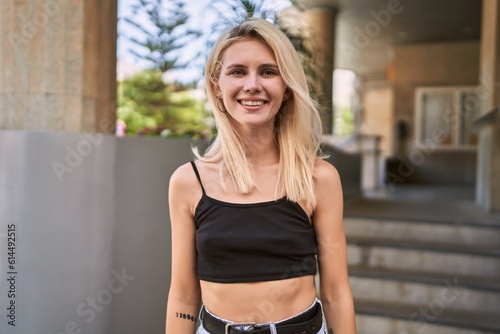 Young blonde woman smiling confident standing at street © Krakenimages.com