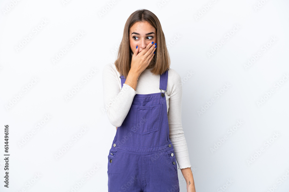 Young caucasian woman isolated on white background doing surprise gesture while looking to the side