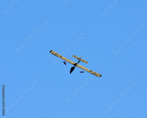 Vintage  Schneider Glider in flight  blue sky and clouds. photo
