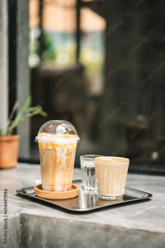 A tempting caramel macchiato paired with a hot latte, gracing the counter of an urban loft-style cafe A tempting caramel macchiato paired with a hot latte, gracing the counter of an urban loft-style cafe