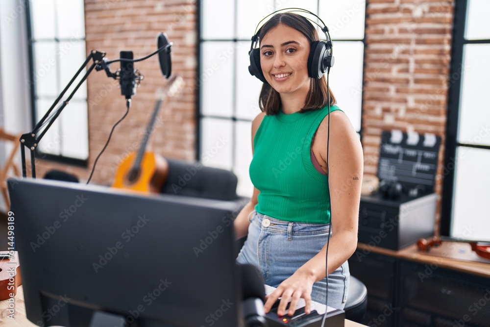 Young hispanic woman musician playing piano keyboard at music studio Young hispanic woman musician playing piano keyboard at music studio