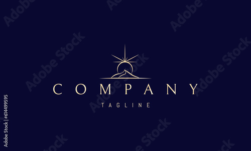 Vector golden logo on which an abstract image of a sand dune with a shining sun above it.