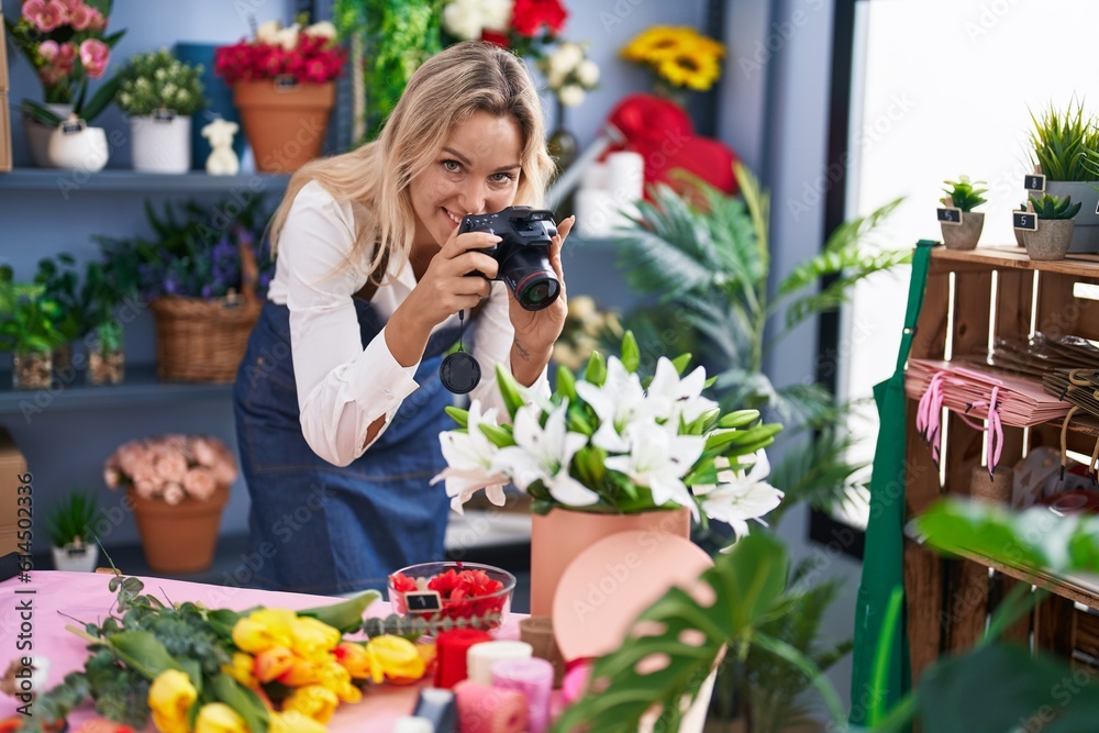 Young blonde woman florist make photo to bouquet of flowes gift at florist