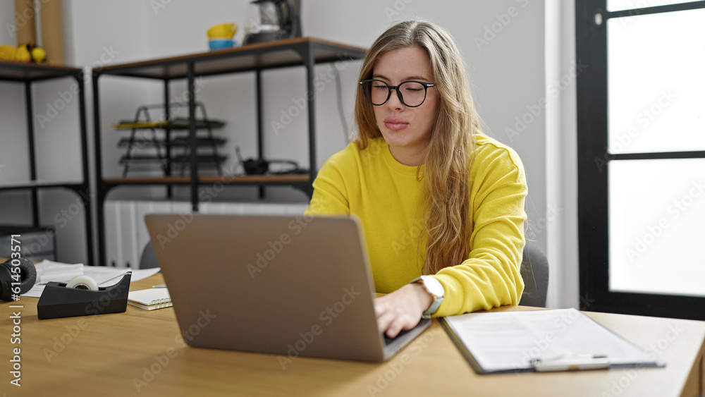 Young blonde woman business worker using laptop working at office Young blonde woman business worker using laptop working at office