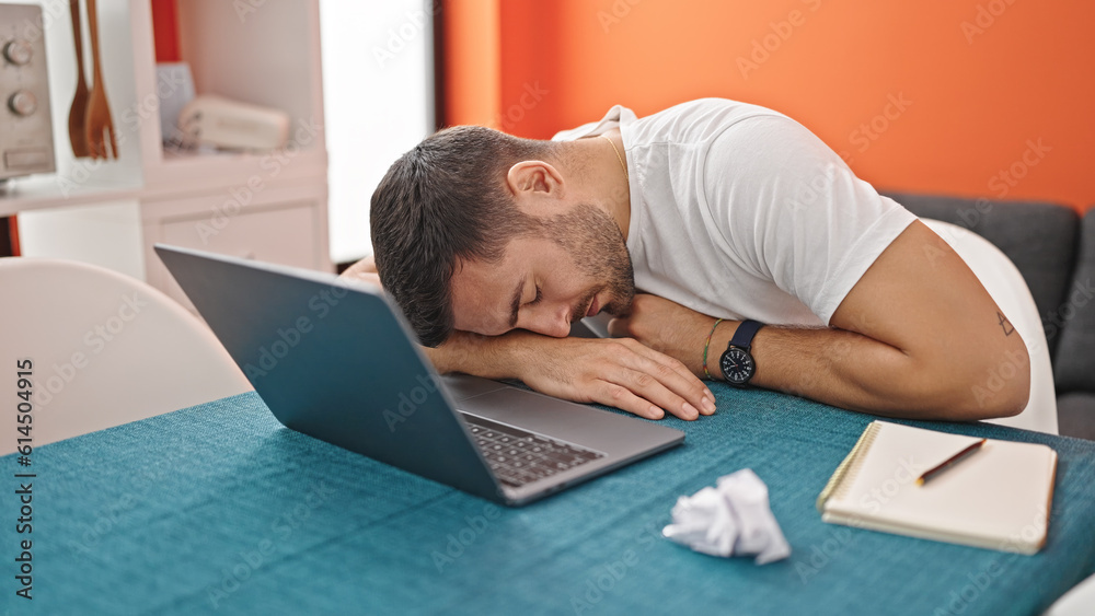 Young hispanic man sleeping on table at dinning room Young hispanic man sleeping on table at dinning room