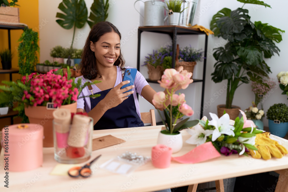 Young african american woman florist smiling confident make photo to flowers at flower shop Young african american woman florist smiling confident make photo to flowers at flower shop