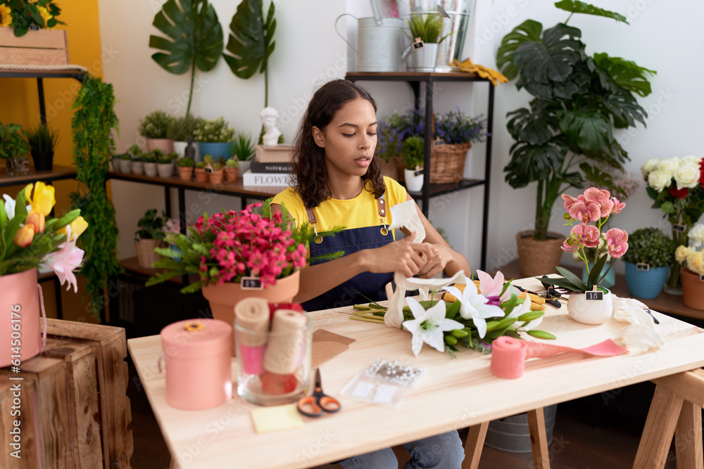 Young african american woman florist make bouquet of flowers at flower shop Young african american woman florist make bouquet of flowers at flower shop