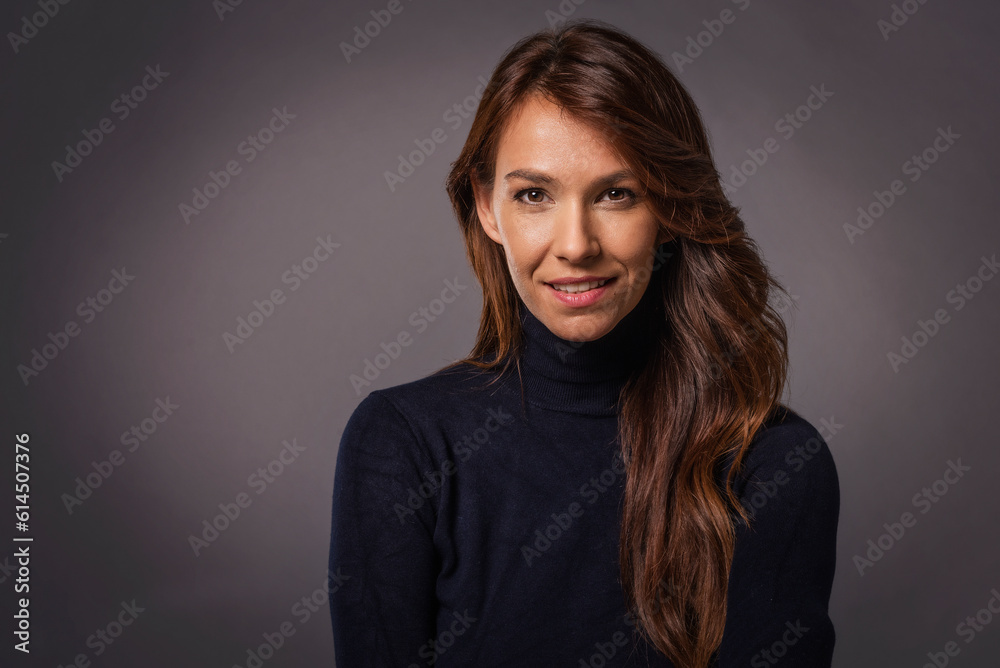Obraz premium Studio portrait of a beautiful middle-aged woman looking at the camera