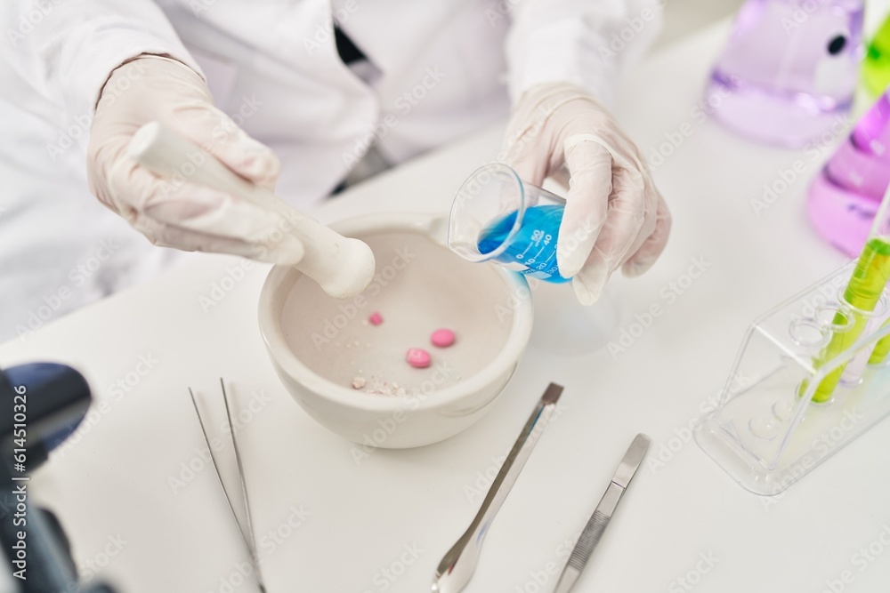 Young beautiful hispanic woman scientist pouring liquid on bowl with pills at laboratory Young beautiful hispanic woman scientist pouring liquid on bowl with pills at laboratory
