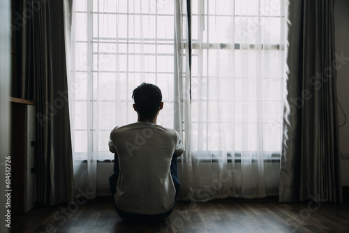 Canvastavla Alone man silhouette staring at the window closed with curtains in bedroom