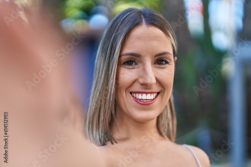 Young beautiful hispanic woman smiling confident making selfie by camera at street