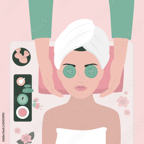 Young woman enjoying relaxing facial massage treatment. Woman lying on back while masseur massaging her face. Facial treatments. Spa face massage, aroma therapy. Happy girl portrait.