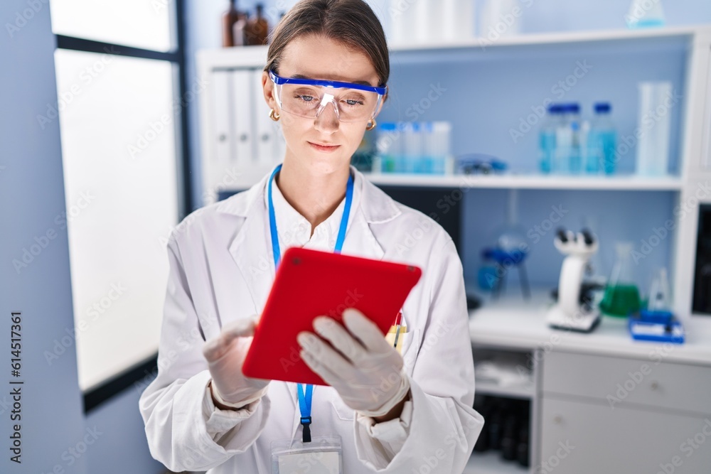 Young caucasian woman scientist using touchpad at laboratory Young caucasian woman scientist using touchpad at laboratory