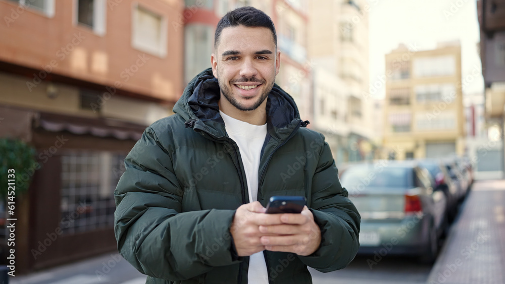 Young hispanic man smiling confident using smartphone at coffee shop terrace Young hispanic man smiling confident using smartphone at coffee shop terrace