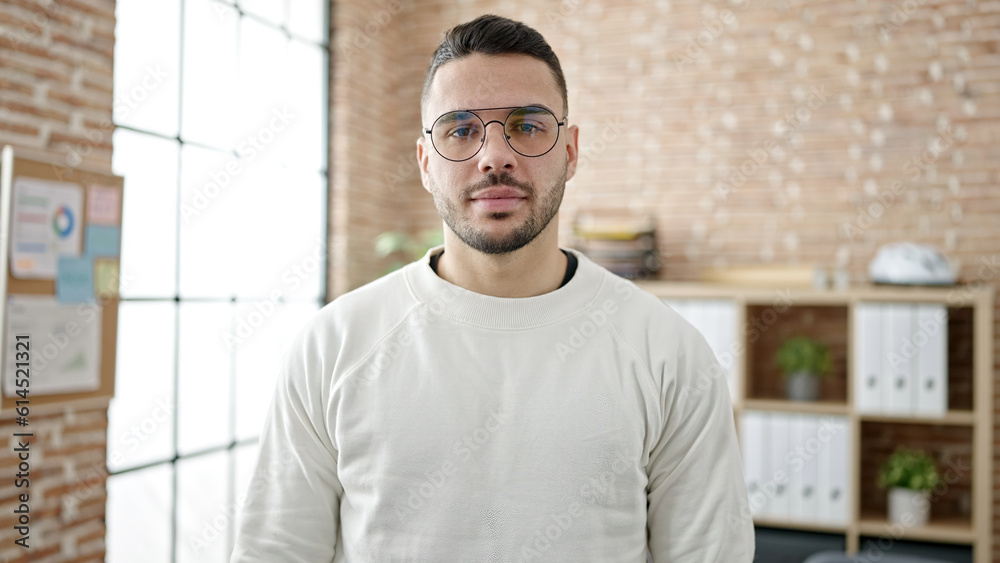 Young hispanic man business worker standing with relaxed expression at office Young hispanic man business worker standing with relaxed expression at office