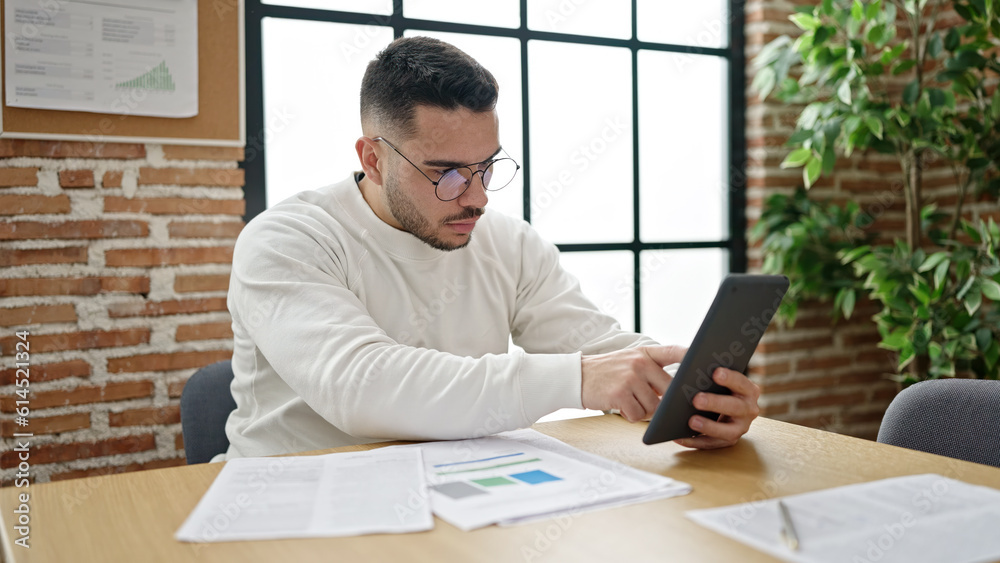 Young hispanic man business worker using touchpad at office Young hispanic man business worker using touchpad at office