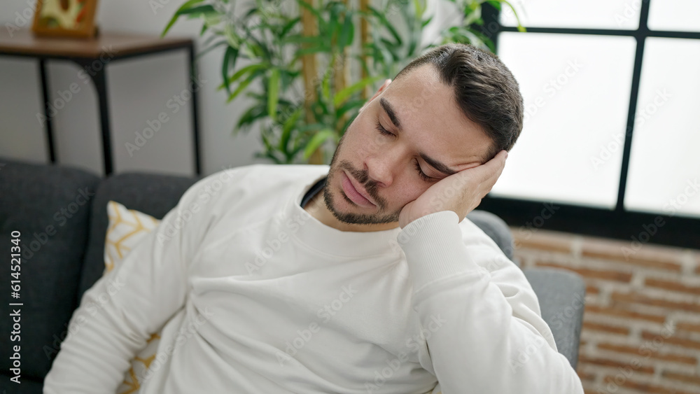Young hispanic man sitting on sofa sleeping at home Young hispanic man sitting on sofa sleeping at home