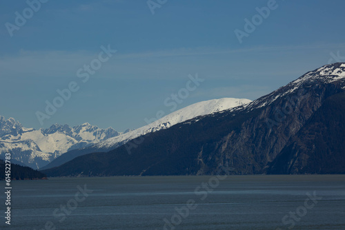 scenic landscape photograph of the snowcapped mountains of Alaska from the ocean view.