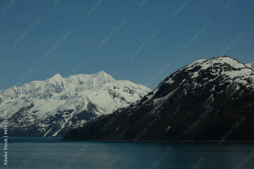 scenic Alaskan snowcapped mountains from an ocean view heading into Juneau Alaska