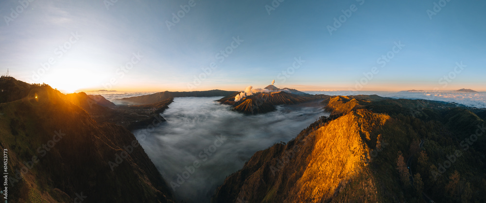 Aerial drone view of Bromo crater Mountain, East Java, Indonesia. man standing on the edge of Bromo crater, high contrast, Bromo Tengger Semeru National Park