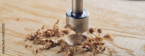 Countersink drill bit with steel triangle ruler make sink in hole for screw in wooden oak plank